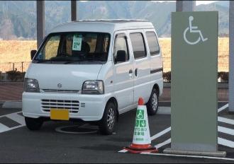 パイロンの横に停車する軽自動車の写真